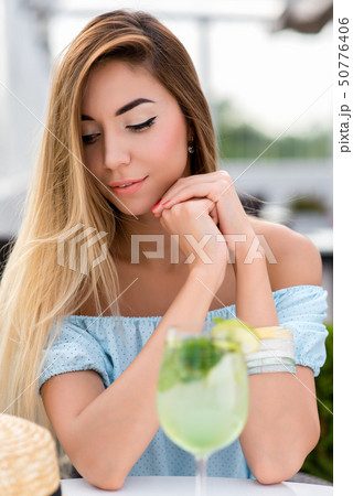 Portrait tender sensual beautiful woman summer cafe. Table glass lime cocktail. Long hair tanned 50776406