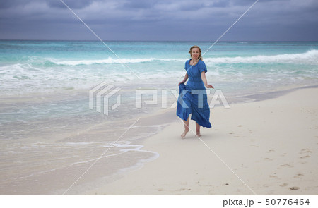woman in a long blue dress goes on the sea coast Cの写真素材 [50776464] - PIXTA