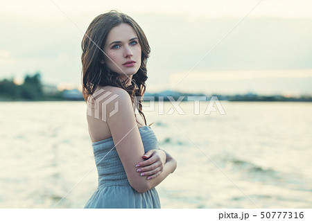 Pretty model girl on ocean background, romantic 50777316