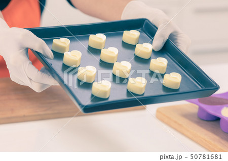 white heart chocolate in box hold by woman 50781681