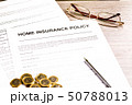 Home Insurance Policy. Pen, Glasses and Coins on Table 50788013
