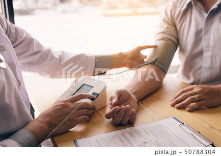Doctor is using a pulse meter to measure the 50788304