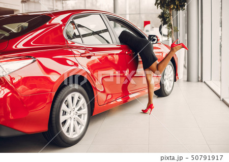 Stylish black woman in a car salon 50791917