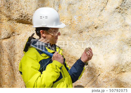 geologist examines a sample of stone outdoor geologist examines a sample of stone outdoor 50792075