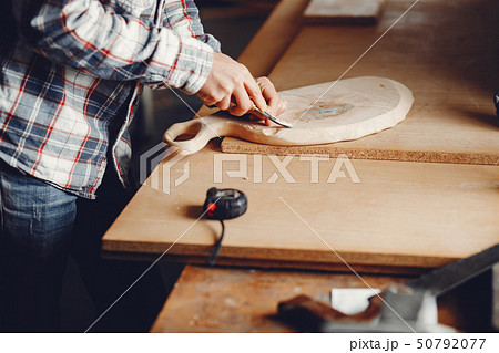 The carpenter works with a tree The carpenter works with a tree 50792077