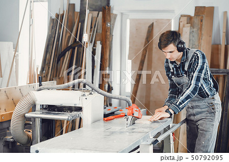 The carpenter works with a tree 50792095