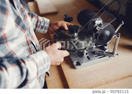 The carpenter works with a tree 50792115