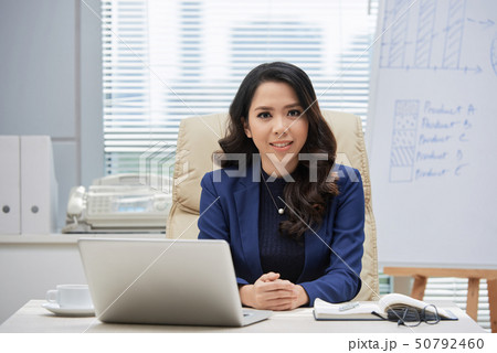 Businesswoman sitting at her workplace at office Businesswoman sitting at her workplace at office 50792460