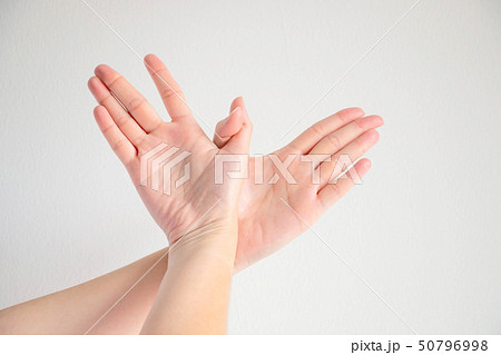 Woman posturing two hands to be bird shape. 50796998