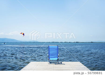 lonely blue deck chair on a pier lonely blue deck chair on a pier 50799691