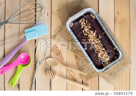 Chocolate cake with almond topping in aluminum 50803379