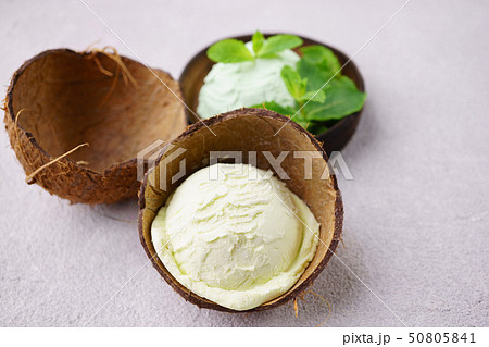 Coconut and mint flavored ice-cream in coco shells Coconut and mint flavored ice-cream in coco shells 50805841
