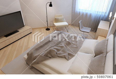Unmade bed in bedroom 50807061