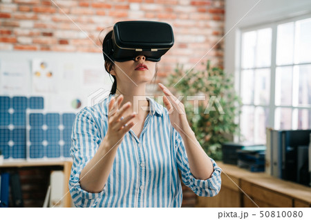 asian woman architect in vr headset at workplace 50810080