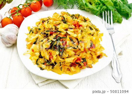 Cabbage stew with chard in plate on board 50811094
