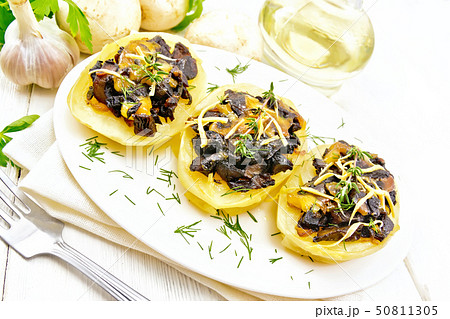 Potatoes stuffed with mushrooms on board Potatoes stuffed with mushrooms on board 50811305