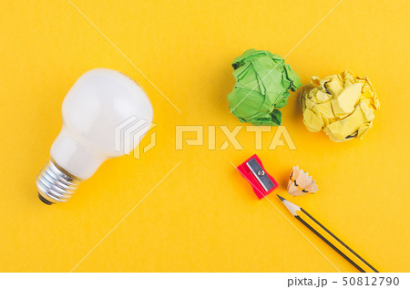 pencil,crumple paper and bulb on yellow background pencil,crumple paper and bulb on yellow background 50812790