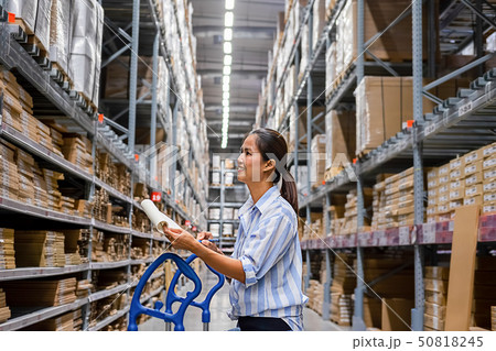 Asian woman with market trolley at furniture store 50818245
