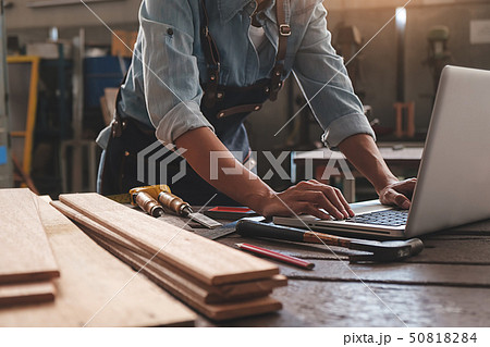 Carpenter working with equipment on wooden table 50818284