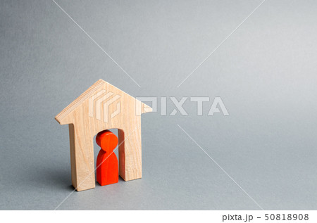 Miniature wooden house with a tenant inside.  50818908
