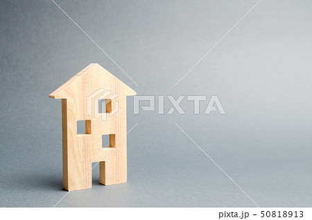 Miniature wooden house on a gray background. 50818913