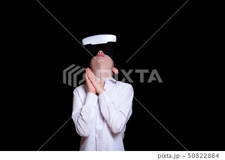 Young boy in a virtual reality helmet. White 50822864