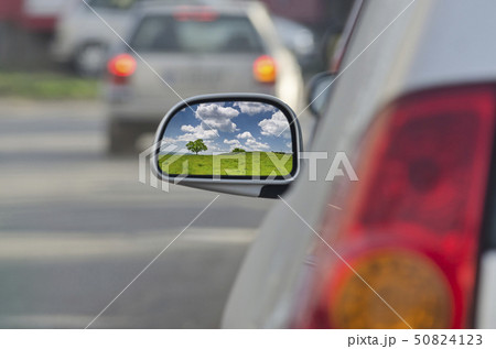 Looking in the side rear-view mirror during the Looking in the side rear-view mirror during the 50824123