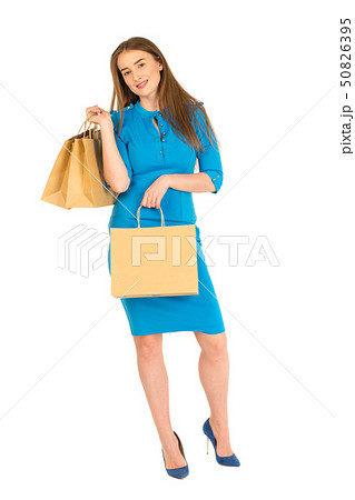 Pretty woman in blue dress posing with bags Pretty woman in blue dress posing with bags 50826395
