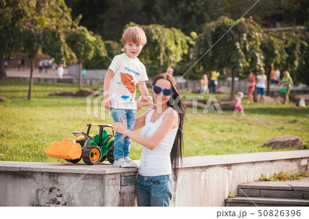 happy family young mother and her five year old son spending time outdoor on a summer day happy family young mother and her five year old son spending time outdoor on a summer day 50826396