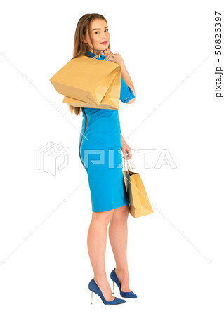 Pretty woman in blue dress posing with bags Pretty woman in blue dress posing with bags 50826397