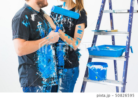 People, renovation and repair concept - close up of lovely couple doing redecoration in apartment 50826595