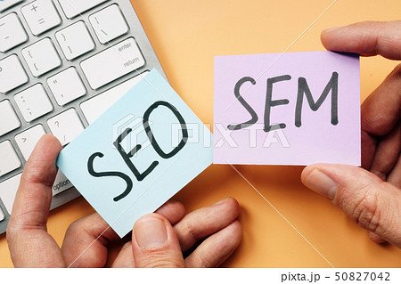 Hands holding cards with SEO and SEM. 50827042