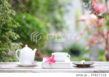 White coffee cup and notebooks on wooden table  50827158