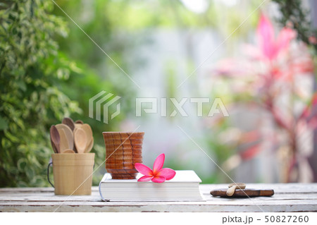 Brown tea cup and books on wooden table Brown tea cup and books on wooden table 50827260