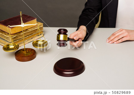 Woman Hand about to bang gavel on sounding block Woman Hand about to bang gavel on sounding block 50829689