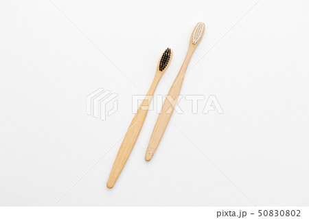 Wooden toothbrushes for the care of teeth on white Wooden toothbrushes for the care of teeth on white 50830802