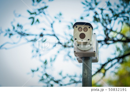 cctv camera on the pole in the park. cctv camera on the pole in the park. 50832191
