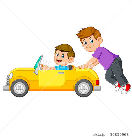 the boy is pushing the yellow car with his friend  50839968