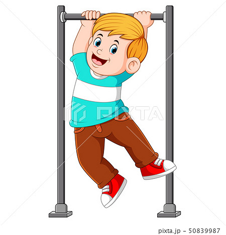 the boy is hanging and holding on the monkey bar	 50839987