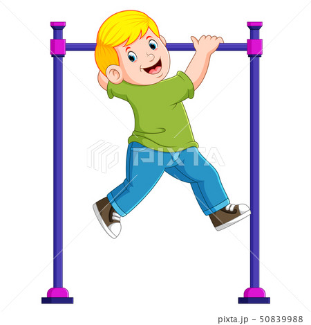 the boy is hanging on the monkey bar	 50839988