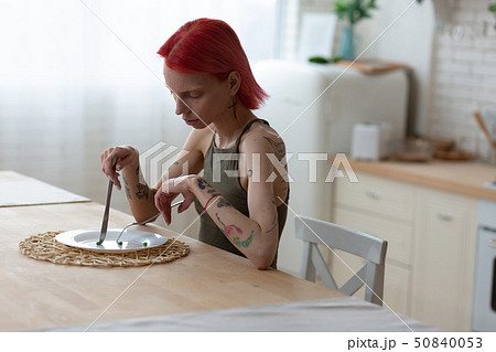Woman with eating disorder eating nothing suffering from anorexia Woman with eating disorder eating nothing suffering from anorexia 50840053