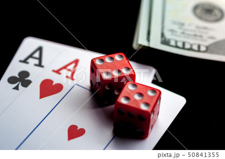 Close-up - Two aces, playing cards and red gaming dices on black table. Close-up - Two aces, playing cards and red gaming dices on black table. 50841355