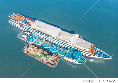Refueling at sea - Small Oil products ship fuelling a large Bulk carrier, aerial image. 50845672