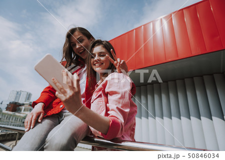 Hipster girls making selfie on city ramp rails 50846034