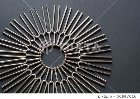 Tuning fork round pattern on a black background Tuning fork round pattern on a black background 50847016