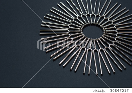 Tuning fork round pattern on a black background 50847017