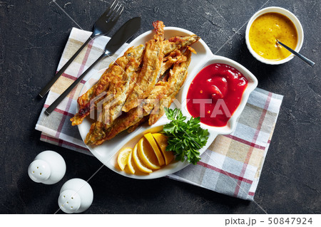Fried small capelins on a white plate 50847924