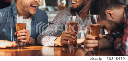 Celebrate meeting. Diverse Friends Drinking Beer And Laughing Celebrate meeting. Diverse Friends Drinking Beer And Laughing 50848459