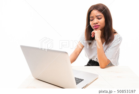 dark-skinned young girl typing on the laptop isolated on background 50853197