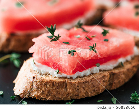 Toasts with watermelon, soft cheese and thyme Toasts with watermelon, soft cheese and thyme 50853650
